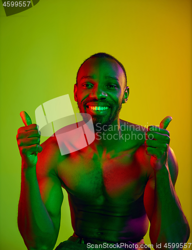 Image of Close up portrait of a young naked african man looking at camera indoors