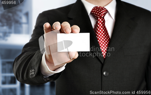 Image of Businessman showing his business card, focus on fingers and card