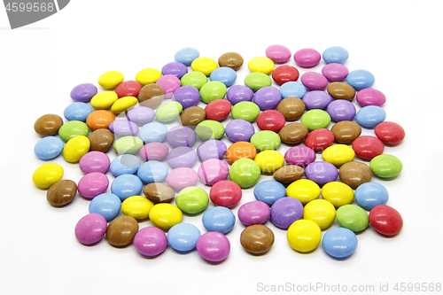 Image of Bright multicolored glazed chocolate candies on white