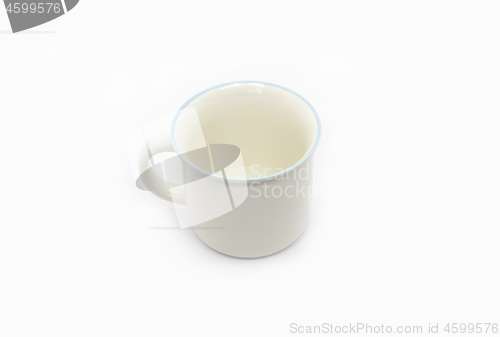 Image of White ceramic cup with handle and blue rim