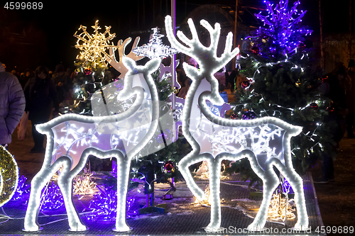 Image of Wonderful holiday illumination of deer figures sparkling with bokeh lights