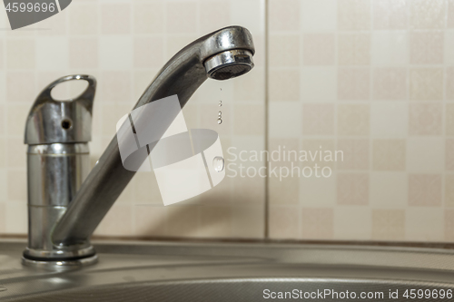 Image of Water dripping from the faucet due to leakage