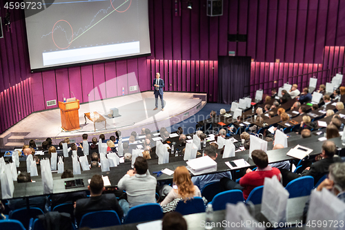 Image of Speaker giving presentation on business conference event.