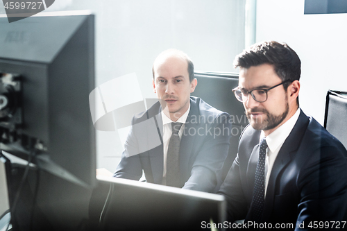 Image of Business team analyzing data at business meeting in modern corporate office.