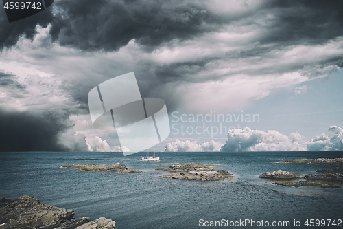 Image of Small boat in dramatic cloudy weather