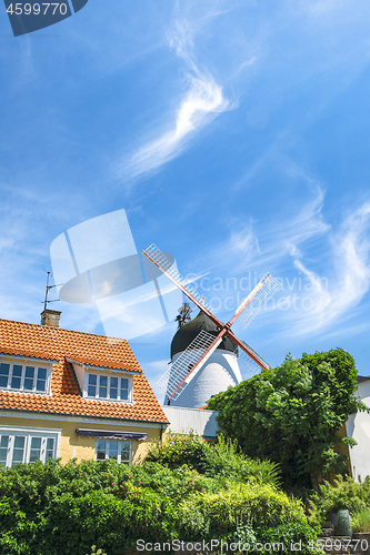 Image of Idyllic mill in a small town under a blue sky