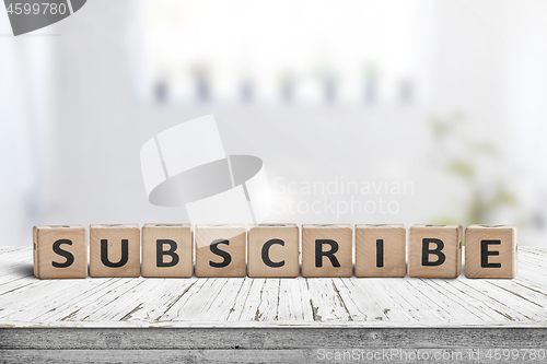 Image of Subscribe word on a wooden sign