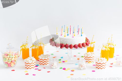 Image of birthday cake, juice, popcorn and marshmallow