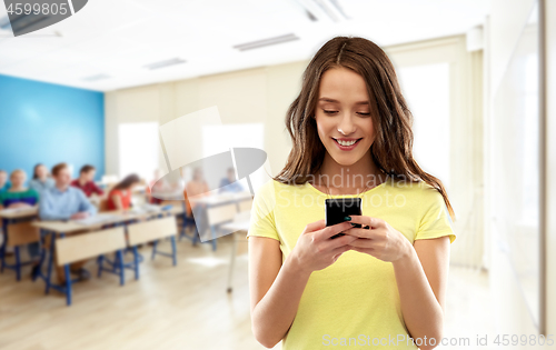 Image of teenage student girl using smartphone at school