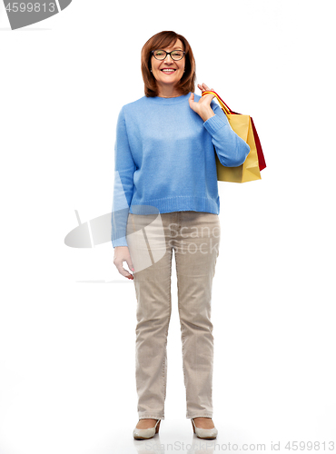 Image of senior woman with shopping bags isolated on white