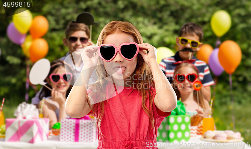 Image of naughty red haired girl in heart shaped sunglasses