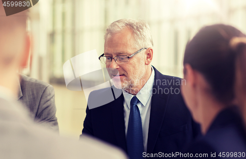 Image of smiling business people meeting in office