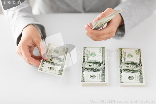 Image of close up of woman hands counting us dollar money