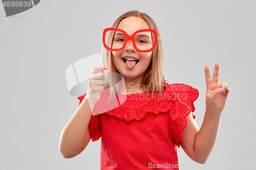 Image of smiling girl with big paper glasses showing peace