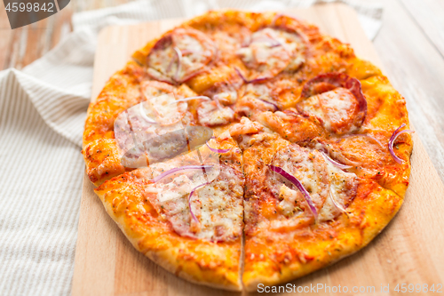 Image of close up of homemade pizza on wooden table