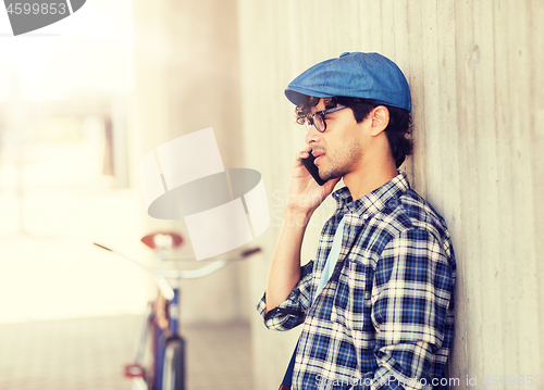 Image of man with smartphone and fixed gear bike on street