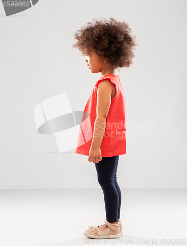 Image of happy little african american girl over grey