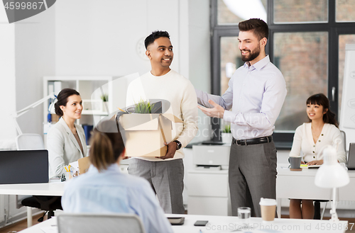 Image of new male employee meeting colleagues at office