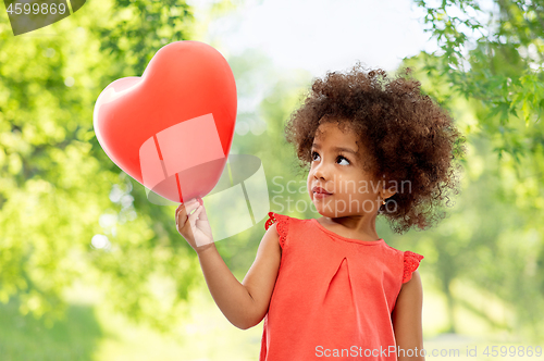 Image of african american girl with heart shaped balloon