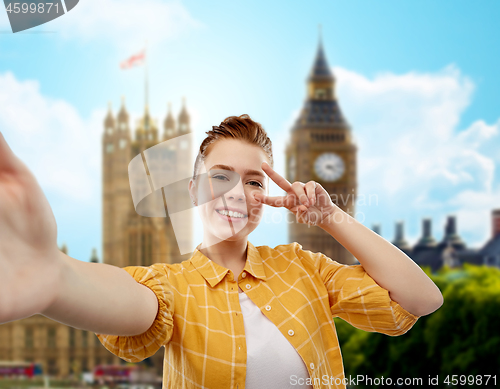 Image of redhead teenage girl taking selfie in london