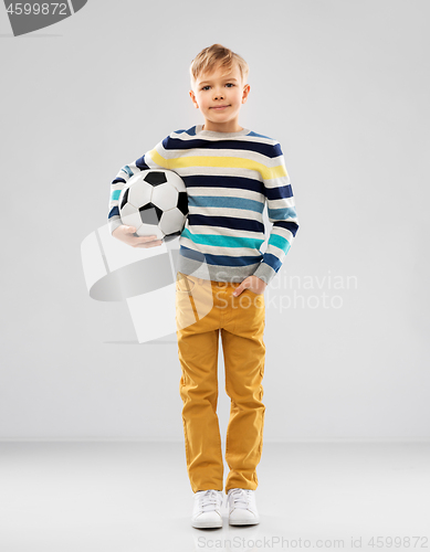 Image of boy in striped pullover with soccer ball