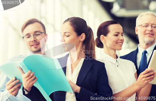 Image of business team with folders meeting at office