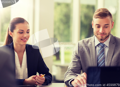 Image of smiling business people meeting in office