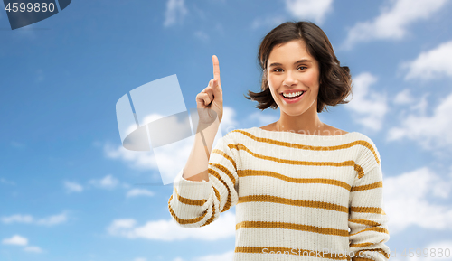 Image of happy woman showing one finger or pointing up