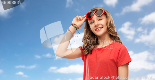 Image of happy teenage girl in red heart shaped sunglasses