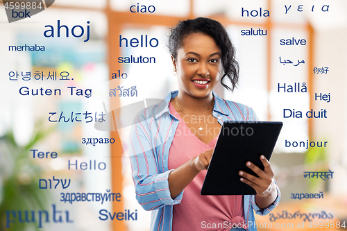 Image of happy african american woman using tablet pc