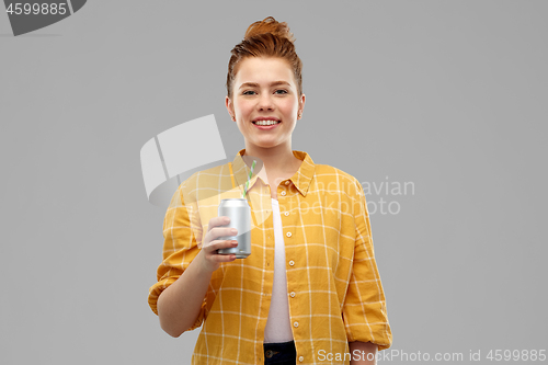 Image of young woman or teenage girl drinking soda from can