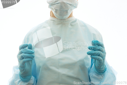 Image of Surgeon in sterile gown, surgical mask and gloves is ready to work