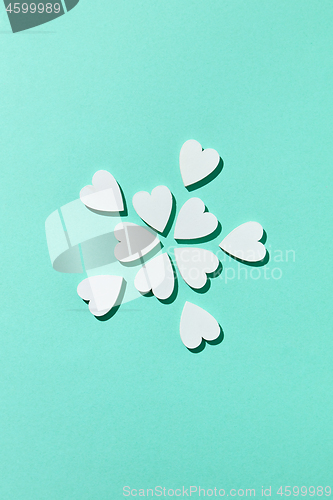 Image of Valentine\'s flowers pattern made from small hearts with shadows.