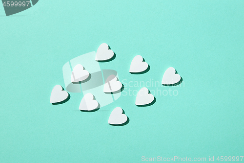 Image of Handmade paper hearts pattern with hard shadows.