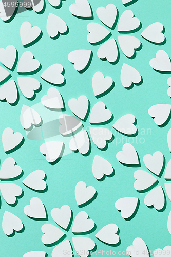 Image of Flowering pattern made from plaster hearts with shadows.