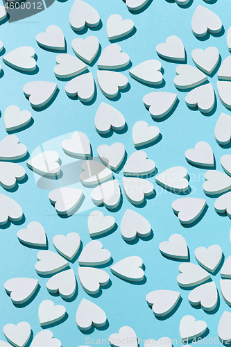 Image of Blooming pattern made from plaster hearts with shadows.