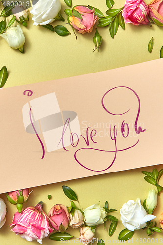 Image of Festive card with text and fresh natural flowers frame.