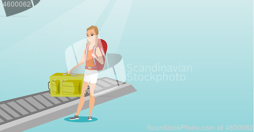 Image of Woman picking up suitcase from conveyor belt.