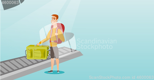 Image of Man picking up suitcase from conveyor belt.