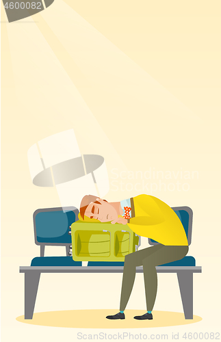 Image of Exhausted man sleeping on suitcase at the airport.