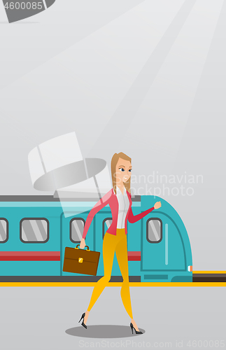 Image of Young woman walking on a railway station platform.