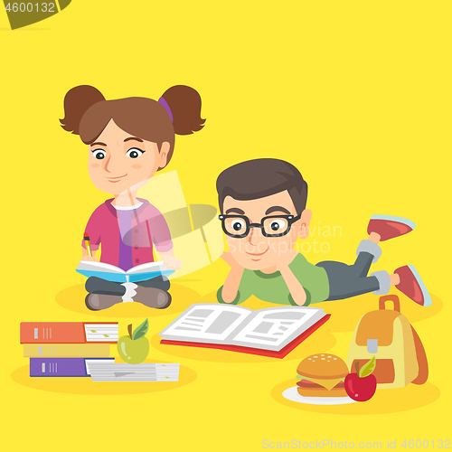 Image of Two caucasian children doing homework together.
