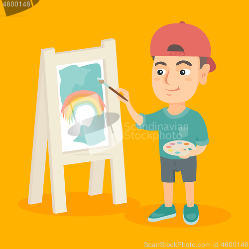 Image of Caucasian boy artist painting picture on a canvas.