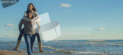 Image of couple having fun at beach during autumn