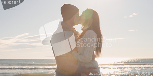 Image of Couple having fun on beautiful autumn day at beach