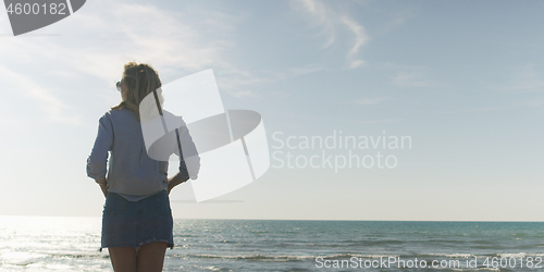 Image of Young woman enjoying the warm autumn day