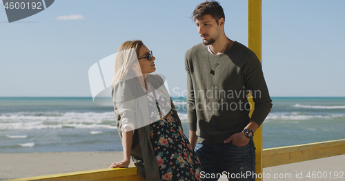 Image of Couple chating and having fun at beach bar