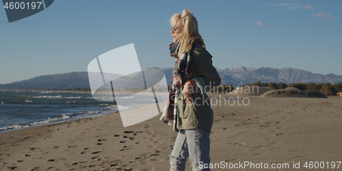 Image of Young woman enjoying the warm autumn day