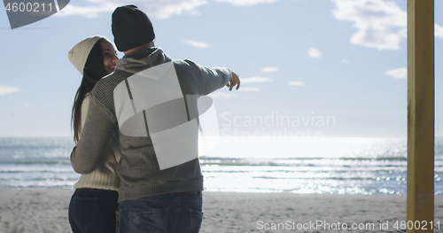 Image of Couple having fun on beautiful autumn day at beach