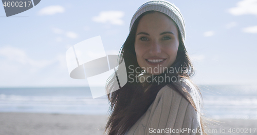 Image of Girl In Autumn Clothes Smiling on beach